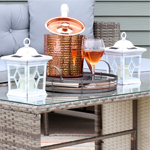 lanterns, wine glasses, and ice bucket on a patio table