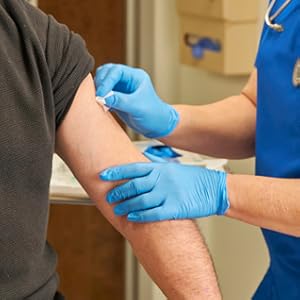 A nurse prepping a patient''s skin wearing McKesson Exam Gloves