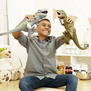 a young child laughs and plays with two boley jurassic t-rex dinosaur toys in a beautiful home 