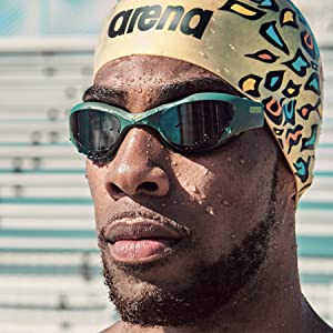 close-up of athlete wearing fun print unisex adult swim cap in gold outdoor pool great for training