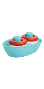 Ubbi boat and buoys bath toy on white. Boat is a light blue and buoys are red and white.